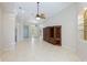 Open living area with tile floors and large windows at 11662 Old Cypress Cv, Parrish, FL 34219