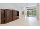 Living room with built-in wooden cabinet and tile flooring at 11662 Old Cypress Cv, Parrish, FL 34219