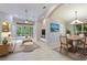 Open living and dining area with tile floors and natural light at 11662 Old Cypress Cv, Parrish, FL 34219