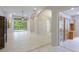 Spacious living room with tile floors and built-in shelving at 11662 Old Cypress Cv, Parrish, FL 34219