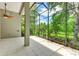 Screened porch with ceiling fan and view of lush landscape at 11662 Old Cypress Cv, Parrish, FL 34219