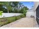 Landscaped backyard, featuring a fire pit and brick pavers at 11813 Holly Hock Dr, Lakewood Ranch, FL 34202