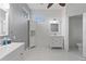 Modern bathroom with white vanity, large mirror, and tiled floor at 11813 Holly Hock Dr, Lakewood Ranch, FL 34202