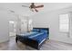 Large bedroom with ceiling fan and access to bathroom at 11813 Holly Hock Dr, Lakewood Ranch, FL 34202