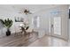 Dining area with a glass-top table and four chairs, stylish decor at 11813 Holly Hock Dr, Lakewood Ranch, FL 34202