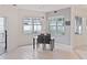 Dining area with a glass-top table and four black chairs at 11813 Holly Hock Dr, Lakewood Ranch, FL 34202