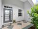 Front entry with a modern door and tiled flooring, welcoming ambiance at 11813 Holly Hock Dr, Lakewood Ranch, FL 34202