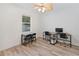 Home office with two desks, chairs, and wood-look flooring at 11813 Holly Hock Dr, Lakewood Ranch, FL 34202