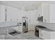 Modern kitchen with white cabinets, granite countertops, and stainless steel appliances at 11813 Holly Hock Dr, Lakewood Ranch, FL 34202