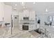 Modern kitchen with white cabinets, granite countertops, and stainless steel appliances at 11813 Holly Hock Dr, Lakewood Ranch, FL 34202