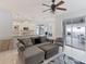 Spacious living room with L-shaped sectional and view of kitchen at 11813 Holly Hock Dr, Lakewood Ranch, FL 34202