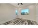 Second bedroom with ocean view and wood-look tile floors at 1214 Gulf Blvd, Englewood, FL 34223