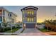 Modern two-story home with gray garage and balcony at 1214 Gulf Blvd, Englewood, FL 34223