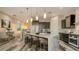 Modern kitchen with large island, stainless steel appliances, and ample counter space at 1214 Gulf Blvd, Englewood, FL 34223