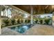 Relaxing pool and spa with covered patio and lush landscaping at 1214 Gulf Blvd, Englewood, FL 34223