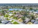 An aerial view showcases the property's proximity to a lake, offering scenic waterfront living in a serene neighborhood at 1219 Sleepy Hollow Rd, Venice, FL 34285