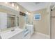 Bright bathroom featuring double vanity sinks, shower with glass doors, and neutral color scheme at 1219 Sleepy Hollow Rd, Venice, FL 34285