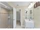 View of a bathroom featuring a glass-door shower, modern vanity, and doorway leading to another room at 1219 Sleepy Hollow Rd, Venice, FL 34285