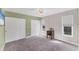 Spacious bedroom with carpet, closet, a ceiling fan, and windows with blinds providing natural light at 1219 Sleepy Hollow Rd, Venice, FL 34285