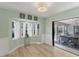 Bright dining area with bay window and sliding glass doors to a screened lanai and pool at 1219 Sleepy Hollow Rd, Venice, FL 34285