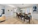 Bright dining room featuring light wood floors and an open layout to the front foyer at 1219 Sleepy Hollow Rd, Venice, FL 34285