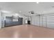 Spacious garage with epoxy floors, storage cabinets, and an automatic garage door opener at 1219 Sleepy Hollow Rd, Venice, FL 34285