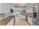 Bright kitchen with white cabinets, stainless steel appliances, and granite countertops at 1219 Sleepy Hollow Rd, Venice, FL 34285