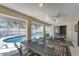 Screened lanai with dining and sitting area offering views of the inviting swimming pool at 1219 Sleepy Hollow Rd, Venice, FL 34285