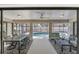 Screened lanai features a dining area and seating area overlooking a private swimming pool at 1219 Sleepy Hollow Rd, Venice, FL 34285