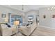 Inviting living room with vaulted ceiling, neutral colors, and sliding door access to the patio at 1219 Sleepy Hollow Rd, Venice, FL 34285