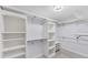 Walk-in closet with adjustable shelving and ample storage space, illuminated by a modern light fixture at 1219 Sleepy Hollow Rd, Venice, FL 34285