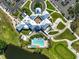 Clubhouse with pool and surrounding landscape, tennis courts, and parking at 1227 Tuscany Blvd, Venice, FL 34292