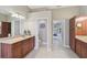 Double vanity bathroom with ample storage and view to bedroom at 1227 Tuscany Blvd, Venice, FL 34292