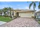 House exterior showcasing a brick driveway and palm trees at 1227 Tuscany Blvd, Venice, FL 34292
