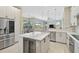 Gourmet kitchen featuring a large island with wine storage and stainless steel appliances at 1227 Tuscany Blvd, Venice, FL 34292
