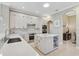 Modern kitchen with white cabinets, quartz countertops, and stainless steel appliances at 1227 Tuscany Blvd, Venice, FL 34292