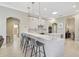 Eat-in kitchen with breakfast bar, white cabinets, and marble countertops at 1227 Tuscany Blvd, Venice, FL 34292