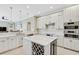 Modern kitchen with white cabinets, marble countertops, and stainless steel appliances at 1227 Tuscany Blvd, Venice, FL 34292