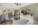 Living room with sliding doors to lanai and pool area, comfortable seating at 1227 Tuscany Blvd, Venice, FL 34292