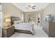 Main bedroom with wooden furniture, ceiling fan and access to backyard at 1227 Tuscany Blvd, Venice, FL 34292