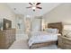 Spacious main bedroom with large dresser, ceiling fan and access to bathroom at 1227 Tuscany Blvd, Venice, FL 34292