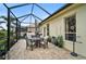 Covered patio with seating and lush landscaping, perfect for outdoor dining at 1227 Tuscany Blvd, Venice, FL 34292