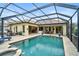 Inviting pool and spa with covered patio, outdoor seating, and lush landscaping at 1227 Tuscany Blvd, Venice, FL 34292