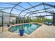 Refreshing pool with screened enclosure, patio, and comfortable seating at 1227 Tuscany Blvd, Venice, FL 34292