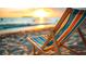 Seaside view of an empty beach chair facing a beautiful ocean sunset at 1305 4Th St # 401B, Sarasota, FL 34236