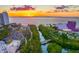 Scenic aerial view of Sarasota bayfront with sunset, park with people, and Van Wezel Performing Arts Hall at 1305 4Th St # 403B, Sarasota, FL 34236