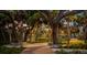 Evening view of a park pathway lit with ambient lighting, surrounded by lush trees at 1305 4Th St # 502B, Sarasota, FL 34236