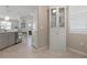 Kitchen features white cabinetry and a view into the dining area at 14369 Eagle Branch Dr, Nokomis, FL 34275