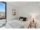 Bedroom with a queen bed, city view, and modern decor at 1558 4Th St # 402, Sarasota, FL 34236