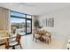 Modern dining area with wooden table and four cushioned chairs and city view at 1558 4Th St # 402, Sarasota, FL 34236